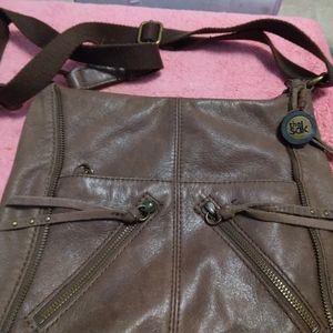 Brand The Sak, soft leather, very detailed, pockets zippers pocket all over